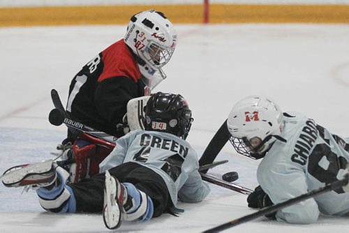 March 30, 2015 - 150330  -  A goaltender make the save at a spring hockey camp Gateway Arena Monday, March 30, 2015. A recent study shows that hockey helmets are not good at protecting against concussions. John Woods / Winnipeg Free Press