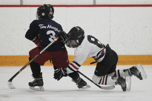 March 30, 2015 - 150330  -  A young player takes a spill at a spring hockey camp Gateway Arena Monday, March 30, 2015. A recent study shows that hockey helmets are not good at protecting against concussions. John Woods / Winnipeg Free Press