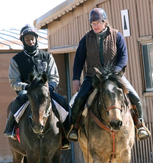 Assiniboia Downs owner trainer Heather Wallerstadt on her pony Teddy, left, with exercise rider Corey Jordan on Dixies Gold Tuesday at Assiniboia Downs- She comments about the federal government not granting the Downs the work permits they need to bring in all the Caribbean grooms and riders that make that place work every year.  -See Paul Wiecek story- Mar 30, 2015   (JOE BRYKSA / WINNIPEG FREE PRESS)