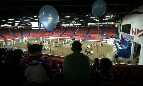 A family takes in the first horse jumping show Monday morning at the Royal Manitoba Winter Fair in Brandon, Manitoba March 30, 2015 at the Keystone Centre.  150330 - Monday, March 30, 2015 - (Melissa Tait / Winnipeg Free Press)