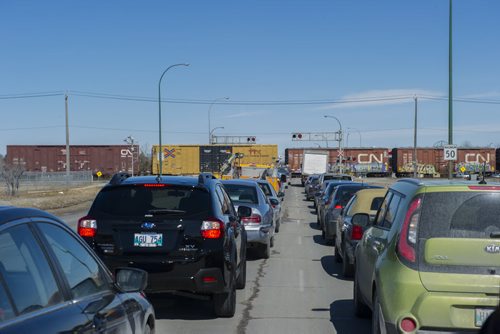150331 Winnipeg - DAVID LIPNOWSKI / WINNIPEG FREE PRESS  Traffic waits for a train to cross the Waverley at Taylor train tracks Tuesday March 31, 2015.
