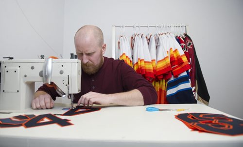 150331 Winnipeg - DAVID LIPNOWSKI / WINNIPEG FREE PRESS  Chris (Keener) Dougherty works on a jersey Tuesday March 31, 2015. Keener and Jason Olson started their company, Keener Jerseys, late last year but Keener has been one of the top jersey customizers in the world for almost 20 years.  Dave Sanderson story