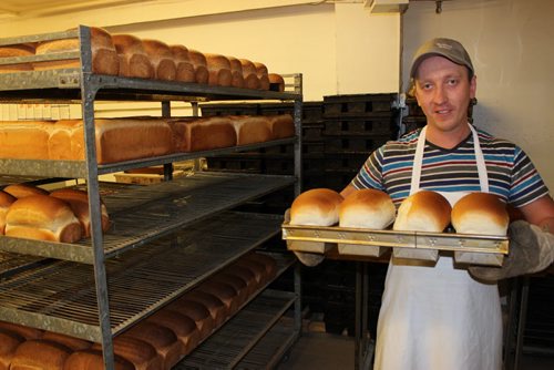 03 -01 - Artem Krokhmalov, from war-torn Eastern Ukraine, with fresh loaves out of the oven at Parkland Bakery in Roblin.   BILL REDEKOP/WINNIPEG FREE PRESS April 1, 2015