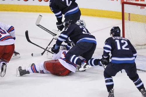 1 of 5 photos.....In a controversial check, Dustin Byfugien winds up to cross checkNew York Ranger's Miller. March 31, 2015 - (Phil Hossack / Winnipeg Free Press)