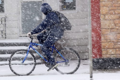 Heavy Snow- A cyclist makes his way through thick snow on Portage Ave near noon in Winnipeg-Standup Photo- Apr 02, 2015   (JOE BRYKSA / WINNIPEG FREE PRESS)