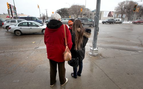 **** (right) and her mother (left) ****walk north main to show a photograph and ask passers by of ****'s daughter **** as they search the north end for the missing 14-year-old. See Gord Sinclair's story. April2, 2015 - (Phil Hossack / Winnipeg Free Press) ***NOTE!! WE CANNOT ID ANY OF THESE WOMEN AT THIS POINT. THE PHOTOS HERE WITH FACES SHOWING ARE TO BE USED ONLY WITH AUTHORIZATION FROM MIKE APORIOUS.***