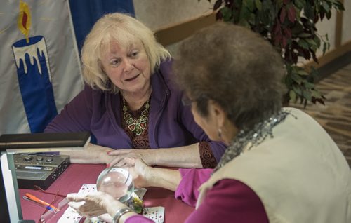 DAVID LIPNOWSKI / WINNIPEG FREE PRESS  Professional psychic Ginger Ella consults a client during a psychic fair at Canad Inns, Regent Ave Friday April 3, 2015. The fair goes all weekend.