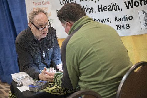 DAVID LIPNOWSKI / WINNIPEG FREE PRESS  Professional psychic David John consults a client during a psychic fair at Canad Inns, Regent Ave Friday April 3, 2015. The fair goes all weekend.