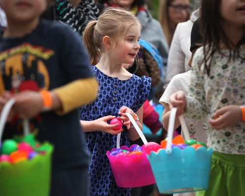 Kids are all smiles as they wait in line to exchange their coloured eggs for chocolate and candies at Shemerdine's first Easter Egg Hunt  event Saturday morning.   Standup photo.    April 4, 2015 Ruth Bonneville / Winnipeg Free Press.