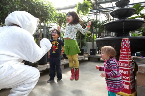 Four-year-old Samuel Sadr, his older sister Julianna, 6yrs and Stella Saper (21 months) dance with a Easter Bunny mascot at Shemerdine's first Easter Egg Hunt  event Saturday morning.   Standup photo.    April 4, 2015 Ruth Bonneville / Winnipeg Free Press.