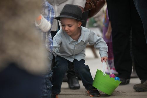 Three-year-old Ashton Criggar looks for more eggs as he waits in line to exchange his coloured eggs for chocolate and candies at Shemerdine's first Easter Egg Hunt  event Saturday morning.   Standup photo.    April 4, 2015 Ruth Bonneville / Winnipeg Free Press.