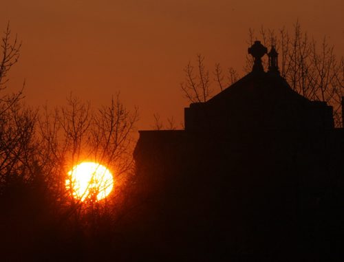 The sun rises near the St. Boniface Cathedral-Basilica Parish Easter Monday in Winnipeg- Standup Photo- Apr 06, 2015   (JOE BRYKSA / WINNIPEG FREE PRESS)