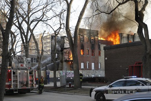April 6, 2015 - 150406  -  Fire crews work on extinguishing a fire at the empty building next to 42 Hargrave Monday, April 6, 2015. John Woods / Winnipeg Free Press