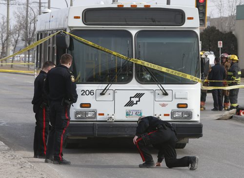 Winnipeg Police at the scene where an elderly woman was killed Tuesday morning after being struck by a city bus at the corner of Keewatin Street and Burrows Avenue. Jenna Dulewich story.Wayne Glowacki/Winnipeg Free Press April 7 2015