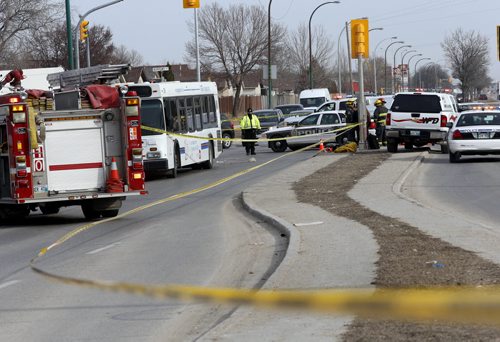 Emergency personal at the scene where an elderly woman was killed Tuesday morning after being struck by a city bus at the corner of Keewatin Street and Burrows Avenue. Jenna Dulewich story.Wayne Glowacki/Winnipeg Free Press April 7 2015