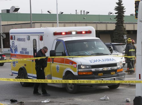 The ambulance prepares to leave the scene where a elderly woman was killed Tuesday morning after being struck by a city bus at the corner of Keewatin Street and Burrows Avenue. Jenna Dulewich story.Wayne Glowacki/Winnipeg Free Press April 7 2015