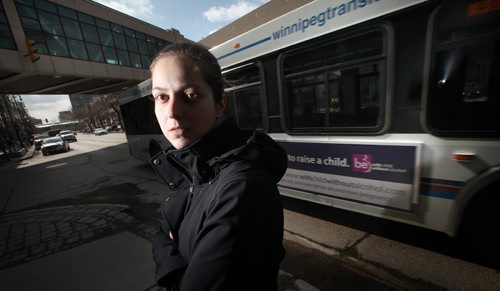 Stacey Manzuik  poses at the SE corner of Carleton st. and Portage ave Wednesday. She was struck by a transit bus here on Nov. 29, 2011 and survived (bus ran a red light). See Kevin Rollason follow to yesterday's pedestrian/Bus fatality. April 8, 2015 - (Phil Hossack / Winnipeg Free Press)  ¤