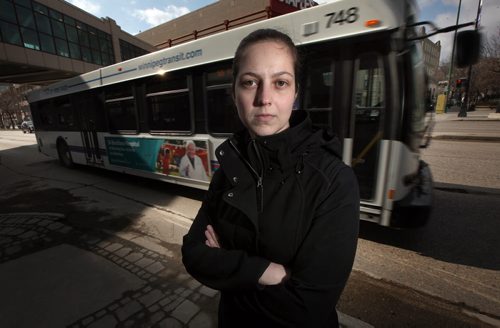 Stacey Manzuik  poses at the SE corner of Carleton st. and Portage ave Wednesday. She was struck by a transit bus here on Nov. 29, 2011 and survived (bus ran a red light). See Kevin Rollason follow to yesterday's pedestrian/Bus fatality. April 8, 2015 - (Phil Hossack / Winnipeg Free Press) ¤