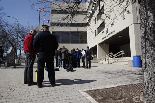 Assistant Commissioner Kevin Brosseau, Commanding Officer (uniform) and Glen Lewis, Executive Director of Policing answer questions from the media outside the RCMP building in Winnipeg Thursday afternoon about suspicious packages sent to MB courts. See Ales Paul story.  April 9, 2015 Ruth Bonneville / Winnipeg Free Press.