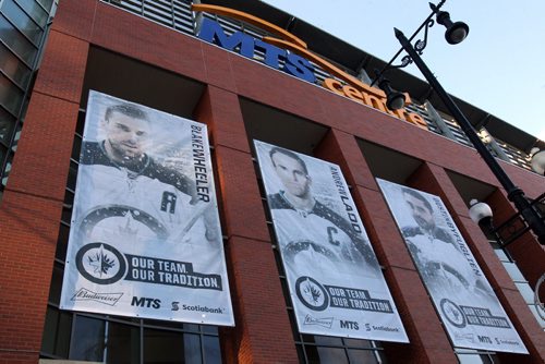 True North Sports and Entertainment hung new White Out playoff banners on the MTS Centre Friday morning after the Winnipeg Jets secured a Stanley Cup playoff berth last night- Standup Photo- Apr 10, 2015   (JOE BRYKSA / WINNIPEG FREE PRESS)