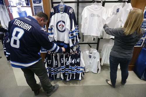 Thousands of Winnipeg Jets fans search and lined up to get their hands on some white Jets merchandise at the Jets Gear store in Winnipeg, Friday, April 10, 2015 after a "whiteout" was announced for their  team's home NHL playoff games.   THE CANADIAN PRESS/John Woods