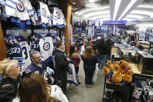 Thousands of Winnipeg Jets fans lined up to get their hands on some white Jets merchandise at the Jets Gear store in Winnipeg, Friday, April 10, 2015 after a "whiteout" was announced for their  team's home NHL playoff games.   THE CANADIAN PRESS/John Woods