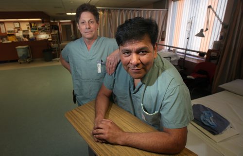 Orthopedic surgeon Dr David Hedden (left) poses with Manuel Fonseca, formerly a physician in Managua Nicaragua who now lives and works in Winnipeg at a Senior Care Home. Manuel has become part of the "Operation Walk" team headed by Hedden which travels to Managua to do joint replacements annually. See Geoff Kirbyson story. (April 10, 2015 - (Phil Hossack / Winnipeg Free Press)