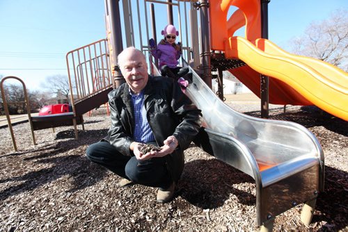 Keith Thomas, retiring soon as risk manager of the Manitoba School Boards Association was partly responsible for implementing safety measures on buses and playgrounds to keep kids safe.  Some of the things he help implement are, safety arms on buses,  Stop signs on buses and soft ground cover under play structures. Also in the photo is three-and-a-half year old Zoey Tepleski who happened to be playing on structure at Richardson Fir Tot Lot with her mom present.  See Nick Martin story.  Ruth Bonneville / Winnipeg Free Press March 26, 2015