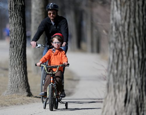 Jesse Hay, 5, and his dad, Cam, riding their bikes in Assiniboine Park, Saturday, April 11, 2015. (TREVOR HAGAN/WINNIPEG FREE PRESS)