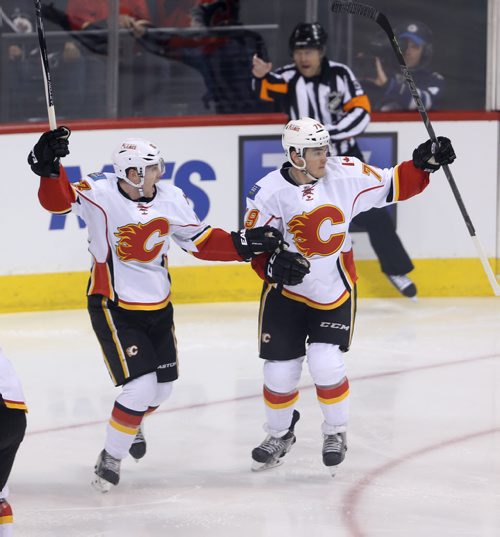 Calgary Flames' Sam Bennett (63) and Michael Ferland (79) celebrate after Ferland opened the scoring in the first minute against the Winnipeg Jets', Saturday, April 11, 2015. (TREVOR HAGAN/WINNIPEG FREE PRESS)