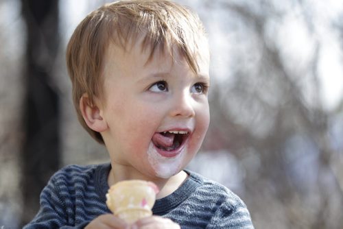 Two-year-old Simon Geisel enjoys his ice cream cone sitting outside with his family  in the warm sunshine at Sargent Sundae Saturday afternoon. Standup   Ruth Bonneville / Winnipeg Free Press March 26, 2015