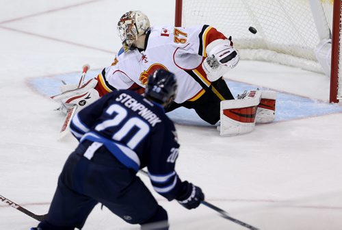 Winnipeg Jets' Lee Stempniak (20) scores on Calgary Flames' goaltender Joni Ortio (37) during third period NHL hockey action, Saturday, April 11, 2015. (TREVOR HAGAN/WINNIPEG FREE PRESS)