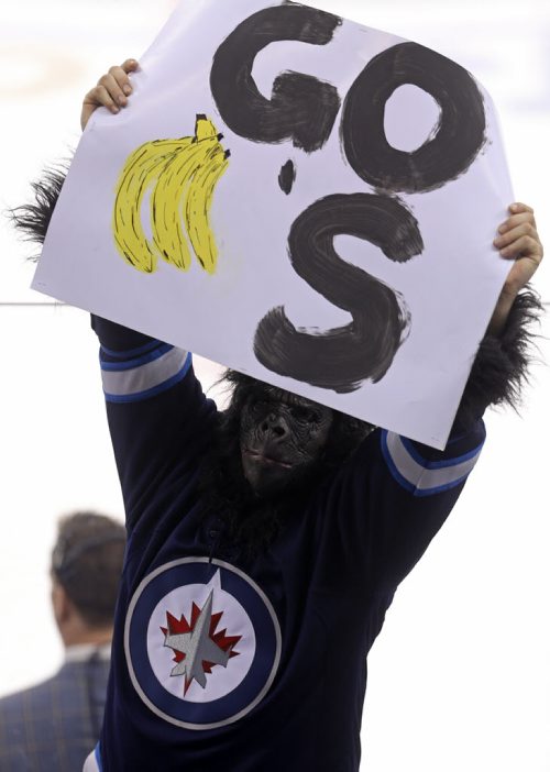 A fan in an ape suit holds a "Go Banana's" sign during third period NHL hockey action between the Winnipeg Jets' and Calgary Flames', Saturday, April 11, 2015. (TREVOR HAGAN/WINNIPEG FREE PRESS)