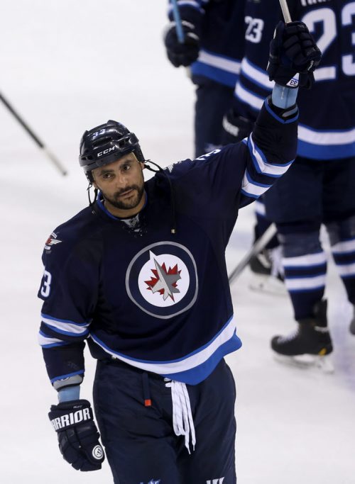 Winnipeg Jets' Dustin Byfuglien (33) salutes the crowd after the team's victory against the Calgary Flames' during NHL hockey action, Saturday, April 11, 2015. (TREVOR HAGAN/WINNIPEG FREE PRESS)