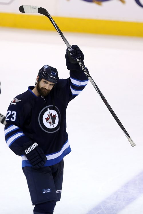 Winnipeg Jets' Jay Harrison (23) celebrates after the team's victory against the Calgary Flames' during NHL hockey action, Saturday, April 11, 2015. (TREVOR HAGAN/WINNIPEG FREE PRESS)