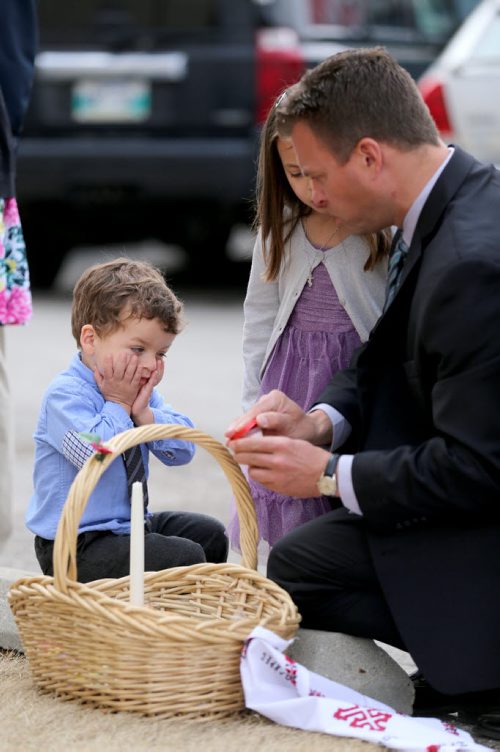 Ken Azaransky with his children Kyle, 2, and Alison,4, preparing an Easter Basket, to be blessed by Metropolitan Archbishop of Winnipeg, Yurij, as he leads Pascha service at Holy Trinity Ukrainian Orthodox Cathedral, Sunday, April 12, 2015. (TREVOR HAGAN/WINNIPEG FREE PRESS)
