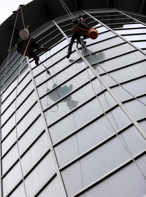 Window washers preparing MTS Centre after the Winnipe Jets' regular season completed Saturday afternoon against the Calgary Flames, Sunday, April 12, 2015. The Jets' first playoff game goes April 16 and the first home game will be next Monday. (TREVOR HAGAN/WINNIPEG FREE PRESS)