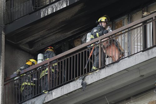 April 12, 2015 - 150412  -  Firefighters attend a fire on an apartment balcony at 429 Westwood Sunday, April 12, 2015. John Woods / Winnipeg Free Press