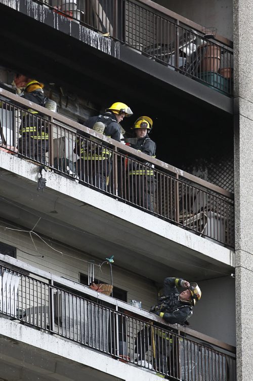 April 12, 2015 - 150412  -  Firefighters attend a fire on an apartment balcony at 429 Westwood Sunday, April 12, 2015. John Woods / Winnipeg Free Press