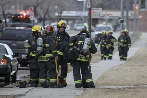 April 12, 2015 - 150412  -  Firefighters attend a fire on an apartment balcony at 429 Westwood Sunday, April 12, 2015. John Woods / Winnipeg Free Press