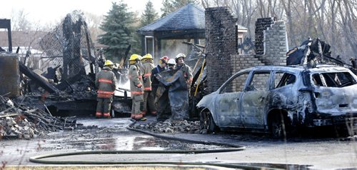 Fire fighters at the scene of a house fire on  Schreyer Crescent in St. Andrews, Mb. Monday morning.  Nick Martin  story Wayne Glowacki/Winnipeg Free Press April 13 2015