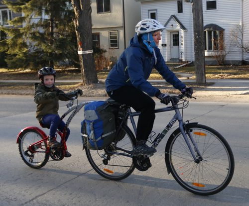 Christine Mesa and her son Ethan ride through Wolseley on beautiful sunny Tuesday morning. Wayne Glowacki/Winnipeg Free Press April 14 2015