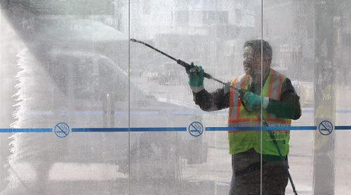 It's that time of the year when various crews are out in force cleaning up our streets after another messy winter. Winnipeg Transit employee Eddie Parco cleans a bus stop at Osborne and Stradbrook Tuesday morning.  150414 April 14, 2015 Mike Deal / Winnipeg Free Press