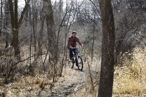 John Labarriere rides his off-road bike through the trails at Bois-des-esprits park land Tuesday afternoon.  One hundred and seventeen acres of City of Winnipeg park land adjacent to the Seine River lies Bois-des-espirits, the largest contiguous river bottom and upland forest environment in the city.  Standup photo  Ruth Bonneville / Winnipeg Free Press April 14, 2015