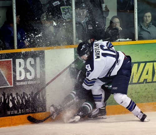 Steinbach Pistons #16 Jonah Wasylak buries Portage Terrier #27 Landon Peel in a spray of snow against the boardsTuesday evening in Steinbach. See Melissa Martin's story. April 14, 2015 - (Phil Hossack / Winnipeg Free Press)