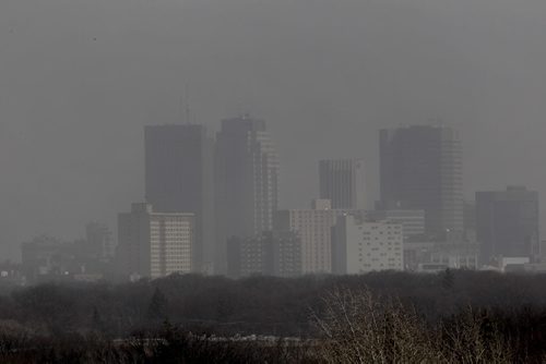 Downtown Winnipeg can barely be seen  from Westview Park, also locally known as "Garbage hill",  Wednesday afternoon due to the high winds kicking up dust and smoke from nearby brush fires.   Standup photo.    Ruth Bonneville / Winnipeg Free Press April 15, 2015