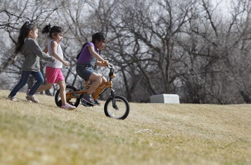 Sisters Maryna Aguilar (5yrs, pink shorts) and Nuvia (6yrs, purple) play with their cousin,  Ivette Aguilar (5yrs, jeans) in the field at Omands Park Wednesday afternoon.   
Standup photo. 
 Ruth Bonneville / Winnipeg Free Press
April 15, 2015