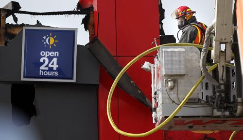 Winnipeg Firefighters hose down a blaze at MacDonalds restraunt in the 900 block of Henderson Highway Wednesday afternoon. Spectators speculated the blaze started when wind blew sparks from an outdoor ashtray ignighting the blaze. See story. April 15, 2015 - (Phil Hossack / Winnipeg Free Press)