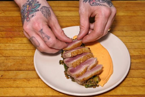 Adam Donnelly chef and owner of Segovia restaurant on Stradbrook prepares a plate of the seared duck breast on lentils.  150415 April 15, 2015 Mike Deal / Winnipeg Free Press