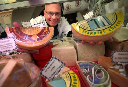 Piazza De Nardi's TOM De NARDI with some of the approximately 400 different types of cheese they sell. For a story on how milk production is at record levels in Manitoba in the wake of a growing demand for cheese, butter and other locally produced or  natural dairy products. Murray McNeill's story. April 16, 2015 - (Phil Hossack / Winnipeg Free Press)